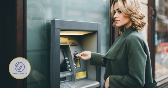 Woman at ATM machine.